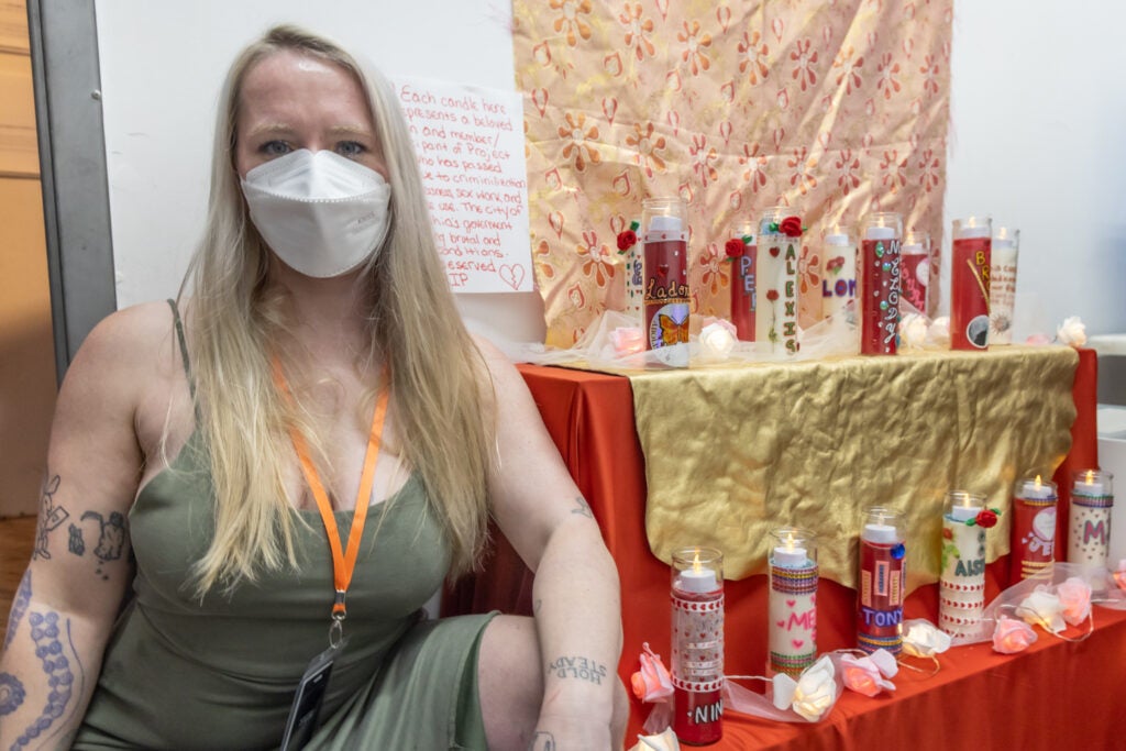 Lore-Elisabeth Blumenthal poses for a photo with part of an exhibition.