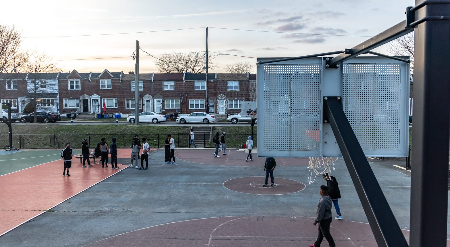 Kids play on a basketball court