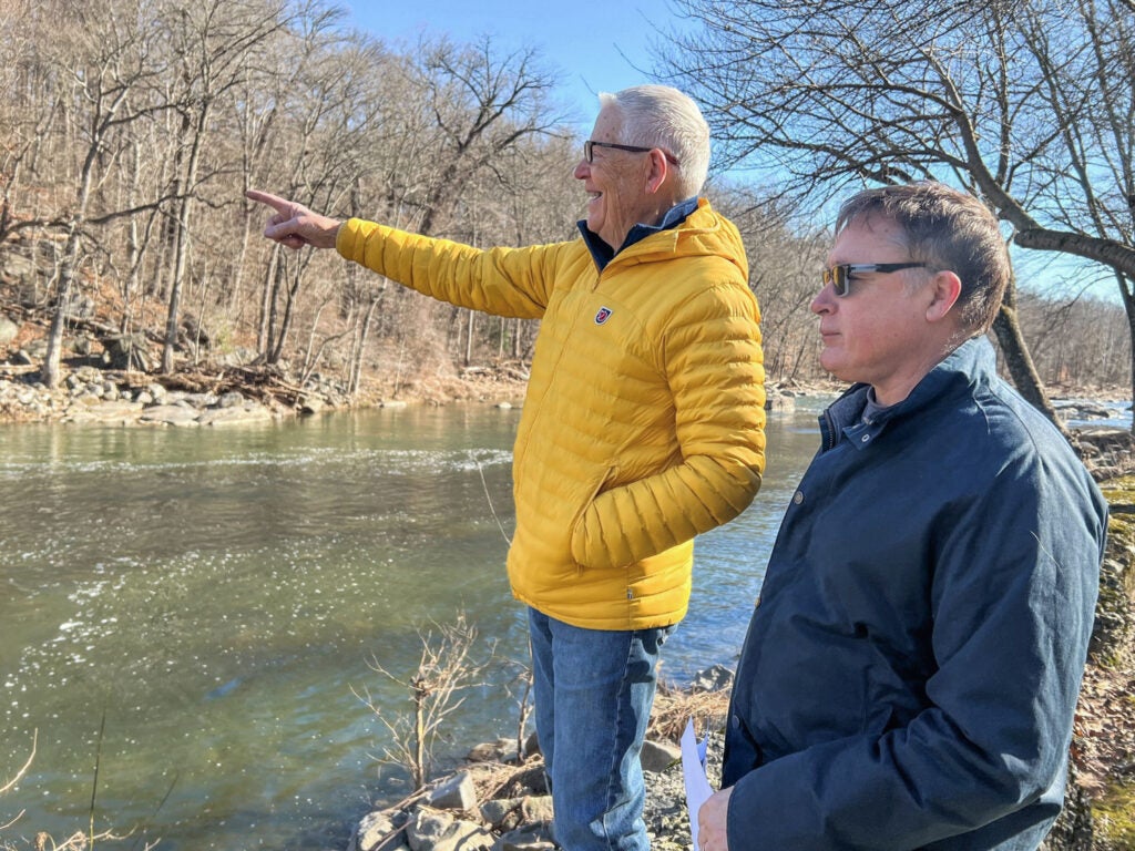 Brandywine Falls residents Bob Hurka (left) and Jim Carrington (right) look out at the Brandywine River