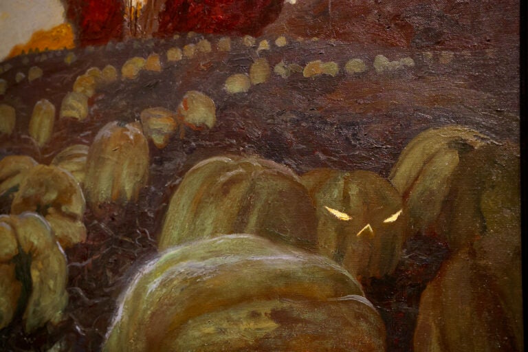 In ''Hill Girt Farm,'' a jack-o-lantern gleams in a field of pumpkins, recording one of Jamie Wyeth's dreams. (Emma Lee/WHYY)