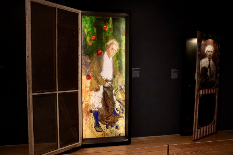 Two paintings from Jamie Wyeth's ''Screen Door Sequence'' are included in ''Unsettled:'' One at left depicts the artist's grandfather, N.C. Wyeth, harvesting apples, and the other depicts Andy Warhol and his dog, Archie. (Emma Lee/WHYY)