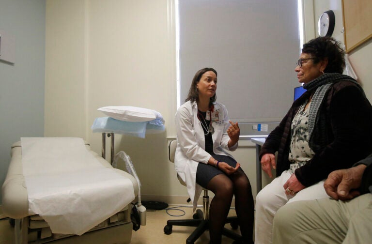 A primary care physician speaks with a patient.