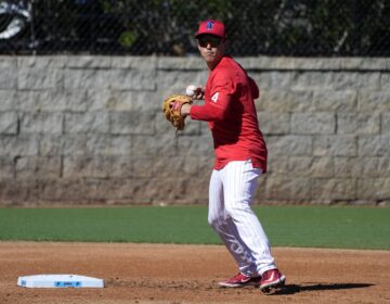 Philadelphia Phillies infielder Scott Kingery throws to first base during a baseball spring training workout Thursday, Feb. 22, 2024, in Clearwater, Fla.