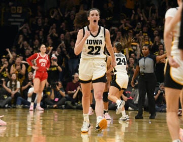 Iowa guard Caitlin Clark (22) celebrates after becoming the all-time leading scorer in NCAA Division I basketball during the first half of a college game against Ohio State, Sunday, March 3, 2024, in Iowa City, Iowa.