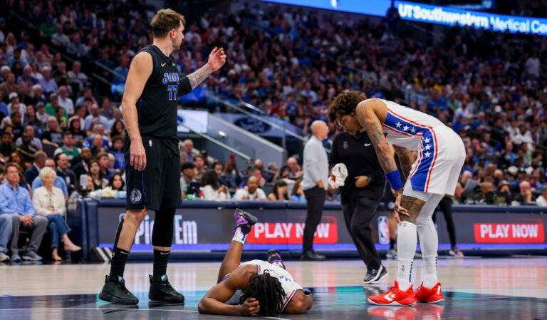 Philadelphia 76ers guard Tyrese Maxey (center) holds his head as Dallas Mavericks guard Luka Doncic (77) and 76ers guard Kelly Oubre Jr. (right) look on during the second half of an NBA basketball game Sunday, March 3, 2024, in Dallas.