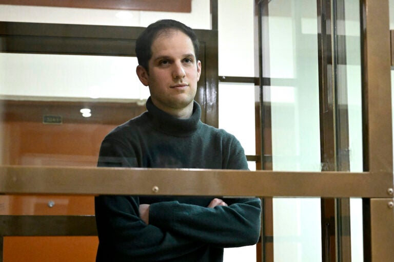 File photo: Wall Street Journal reporter Evan Gershkovich stands in a glass cage in a courtroom at the Moscow City Court, in Moscow, Russia, on Dec. 14, 2023. A lawyer for The Wall Street Journal said Thursday, March 21, 2024, that Russia must face consequences for its detention of Gershkovich, one of the newspaper's reporters. Gershkovich was arrested on March 29, 2023, on espionage charges, which he and the newspaper deny.