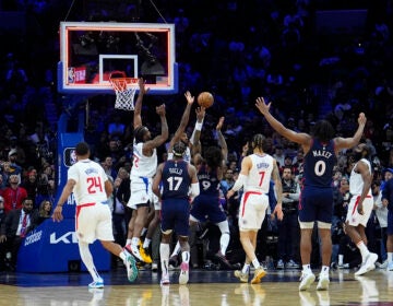 Philadelphia 76ers' Kelly Oubre Jr. (9) cannot get a shot past Los Angeles Clippers' Paul George (13) and Kawhi Leonard (2) as time expires in their NBA basketball game, Wednesday, March 27, 2024, in Philadelphia. (AP Photo/Matt Slocum)