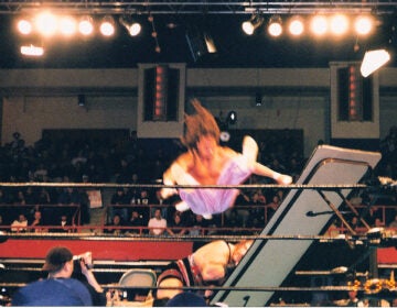 ECW wrestler Sabu flies through the air onto an opponent and a table as part of the promotion's hardcore style. (Source: Flickr Commons project, Jonathan Ice, https://commons.wikimedia.org/w/index.php?curid=5934466)