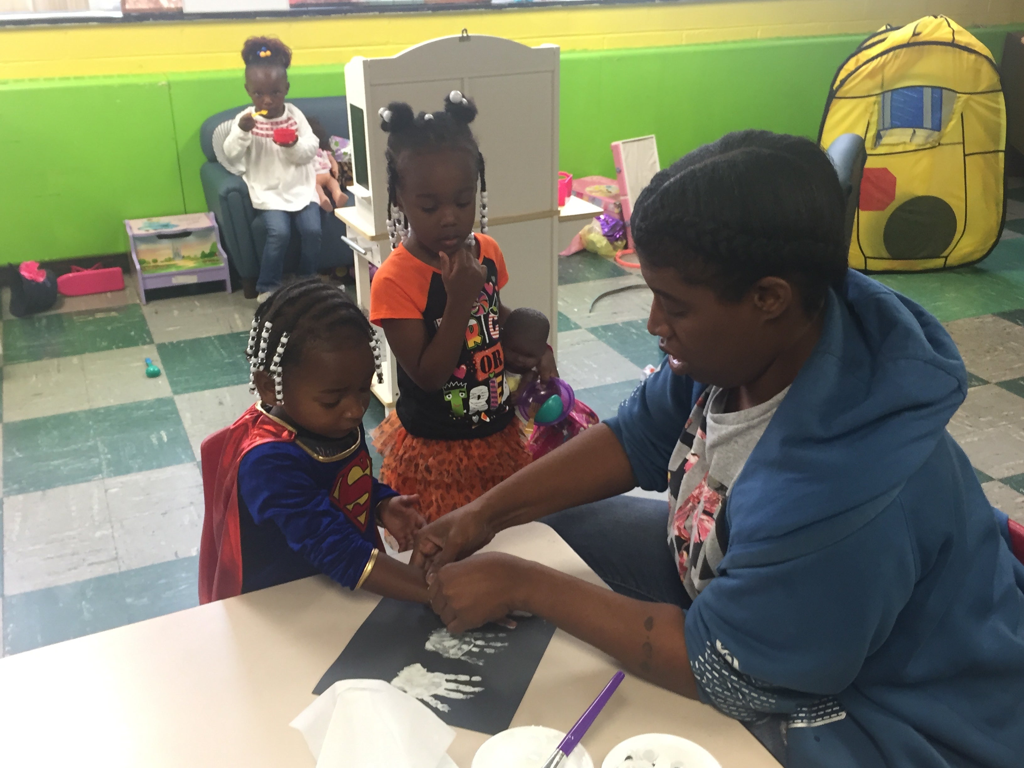 A caregiver works with children 