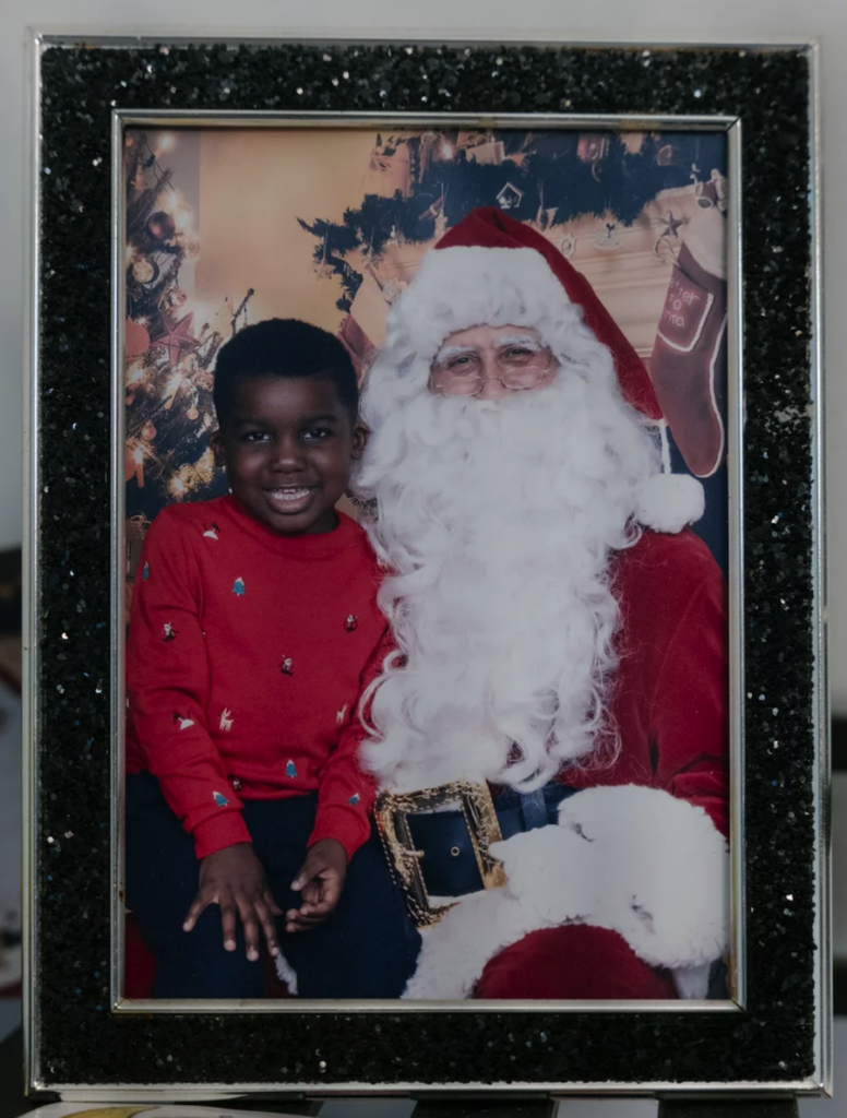 A.J. posing for a photo sitting on Santa's lap