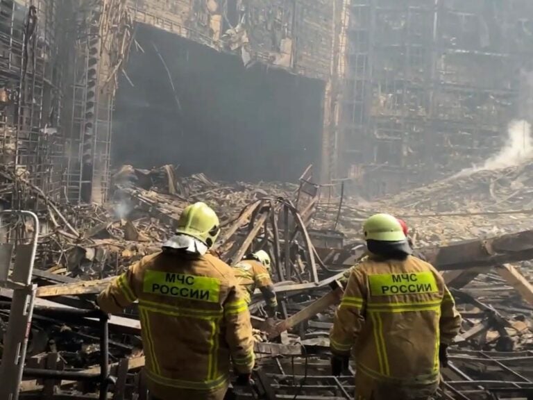 Firefighters work in the burned concert hall after an attack on the western edge of Moscow, Russia.