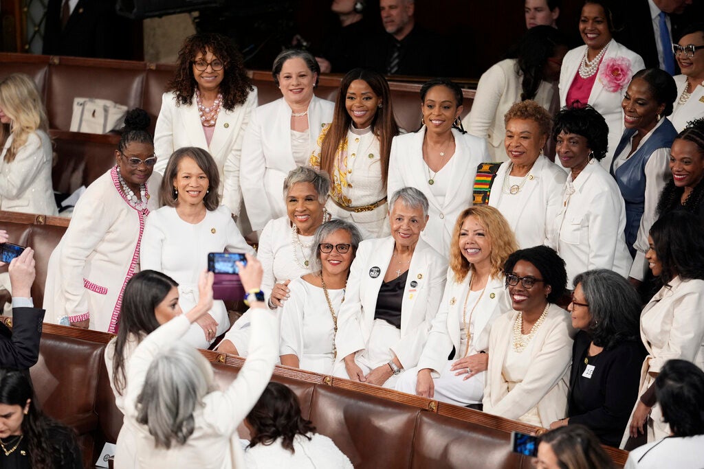 Women members of the House of Representatives, pose for photos before President Joe Biden arrives to deliver his State of the Union address to a joint session of Congress, at the Capitol in Washington, Thursday, March 7, 2024.