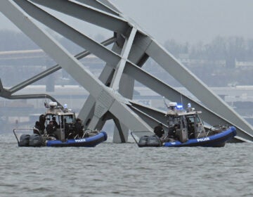 Police recovery crews work near the collapsed Francis Scott Key Bridge after it was struck by the container ship Dali in Baltimore. Eight members of a construction crew repairing potholes were on the bridge when the structure fell into the Patapsco River at around 1:30 a.m. on Tuesday.