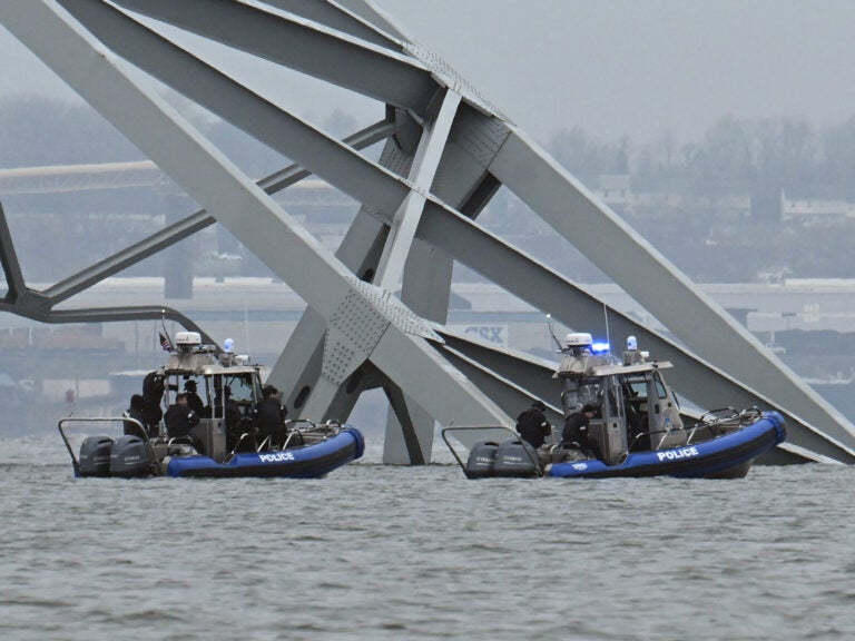 Police recovery crews work near the collapsed Francis Scott Key Bridge after it was struck by the container ship Dali in Baltimore. Eight members of a construction crew repairing potholes were on the bridge when the structure fell into the Patapsco River at around 1:30 a.m. on Tuesday.