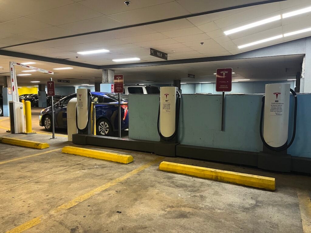 A row of chargers in a garage