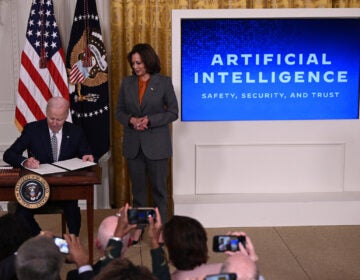 US Vice President Kamala Harris looks on as US President Joe Biden signs an executive order after delivering remarks on advancing the safe, secure, and trustworthy development and use of artificial intelligence, in the East Room of the White House in Washington, DC, on October 30, 2023. Biden issued an executive order October 30, 2023, on regulating artificial intelligence, aiming for the United States to 