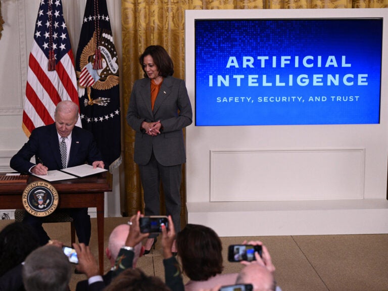 US Vice President Kamala Harris looks on as US President Joe Biden signs an executive order after delivering remarks on advancing the safe, secure, and trustworthy development and use of artificial intelligence, in the East Room of the White House in Washington, DC, on October 30, 2023. Biden issued an executive order October 30, 2023, on regulating artificial intelligence, aiming for the United States to 