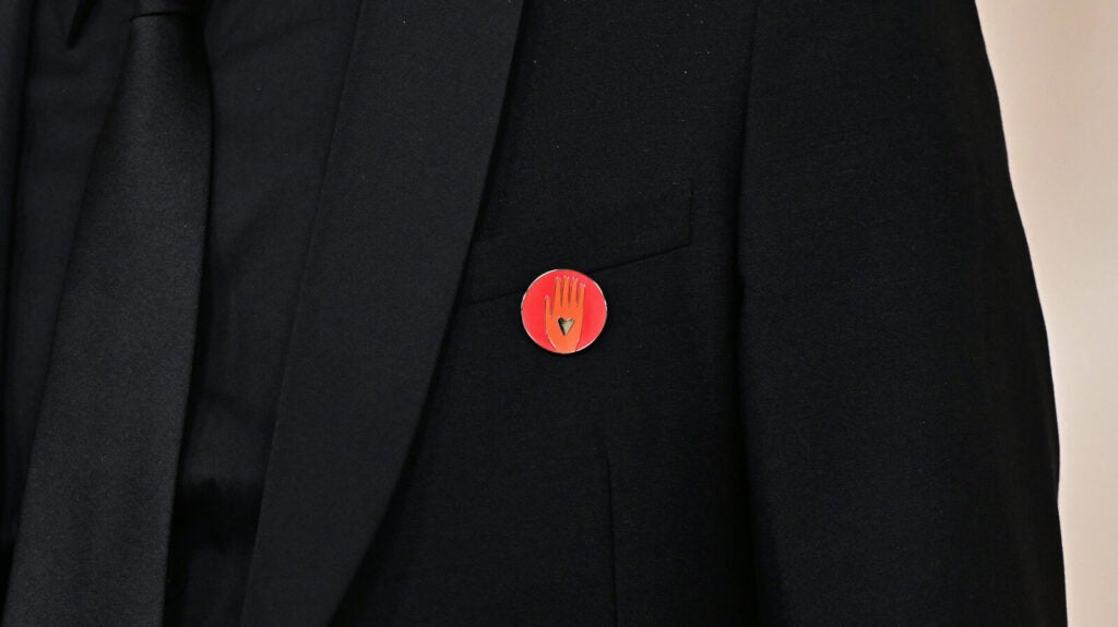 Nadim Cheikhrouha, producer for the Oscar-nominated documentary Four Sisters, wears an Artists4Ceasefire pin as he attends the Academy Awards on Sunday. The pin features a hand with a black heart in the middle of it. 