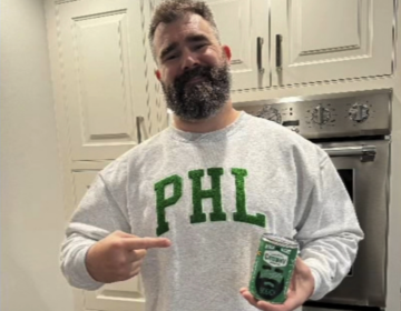 Jason Kelce holding a can of soup