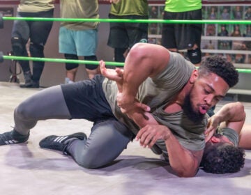 Wrestler Christian Darling pins a contender in the ring at the Monster Factory in Paulsboro, N.J. (Kimberly Paynter/WHYY)