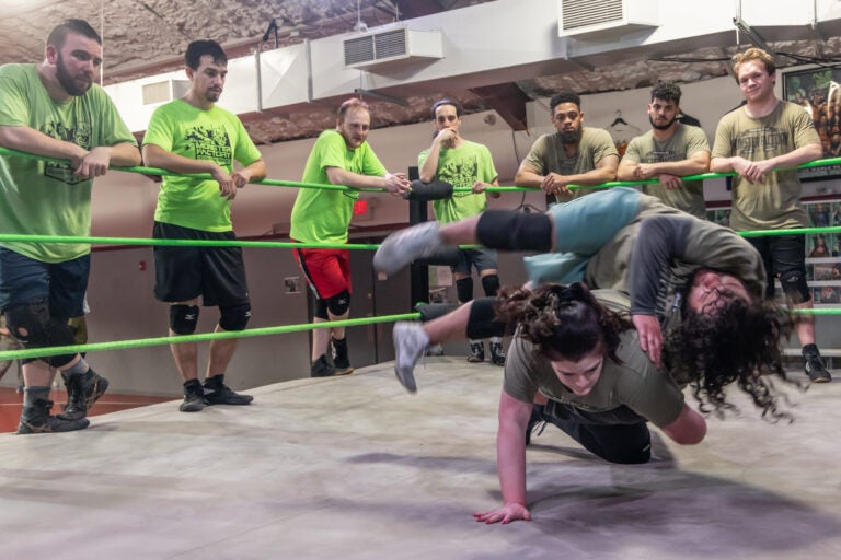 Gabi Franciosa, aka wrestler Stevie Brooks, flips an opponent in the ring at the Monster Factory in Paulsboro, N.J. (Kimberly Paynter/WHYY)