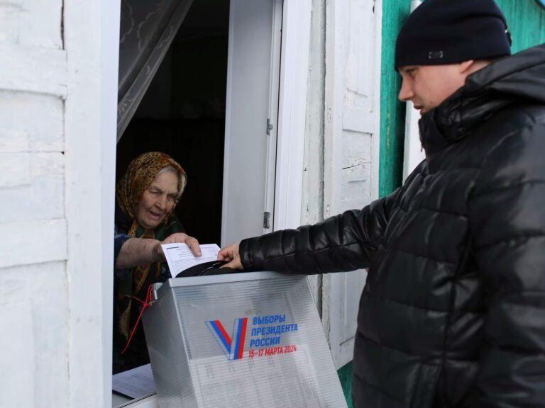 A woman casts a ballot in Russia