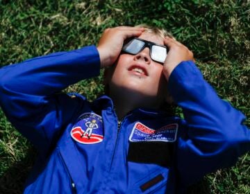 Tyler Hanson, of Fort Rucker, Ala., watches the sun moments before the total eclipse, Monday, Aug. 21, 2017, in Nashville, Tenn.