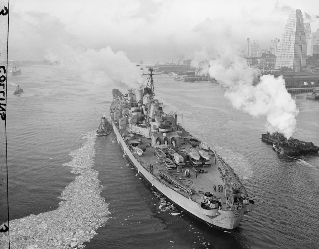 The Battleship USS New Jersey passes under the Brooklyn Bridge
