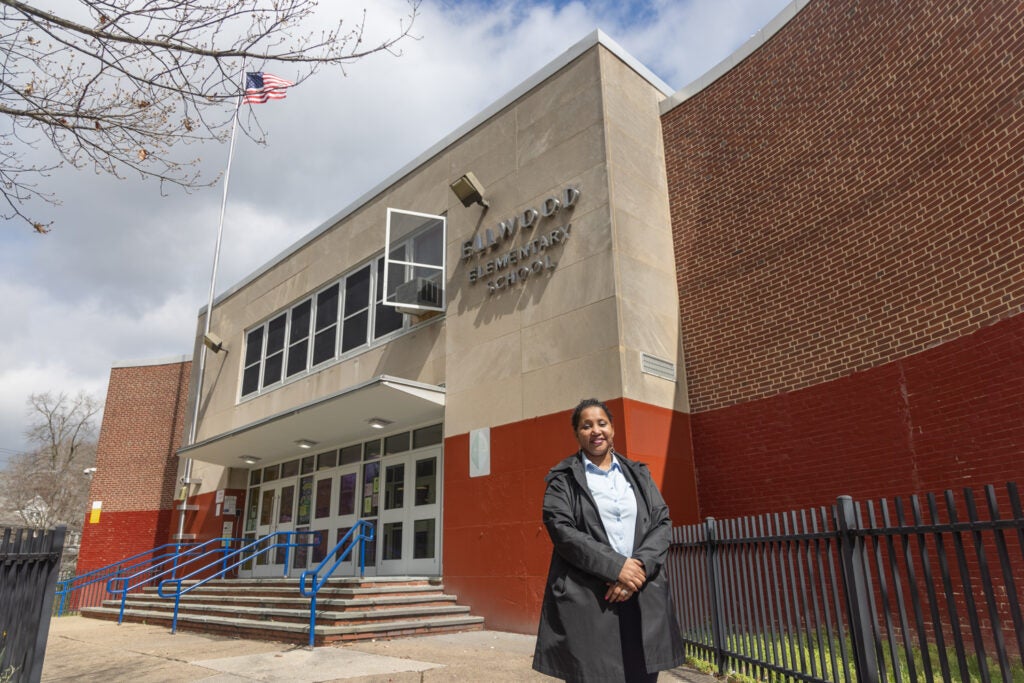 Michelle Gibbs posing in front of the school