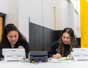 Poll workers Maria Moreira, Lincoln High School class of ’23 (left) and senior Victorya Santos at work in the school’s gymnasium