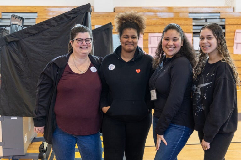 (From left) Sarah Caswell, a special education and science teacher at Lincoln High School, with young poll workers, junior Didianna Victorino, alum Maria Moreira and senior Victorya Santos, in the school’s gymnasium on primary Election Day April 23, 2024.