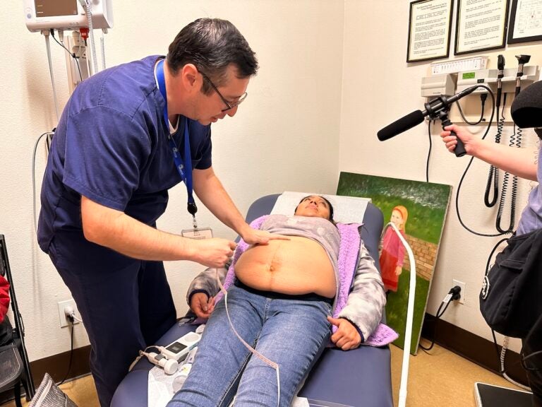 Dr. Armando Moreno performs an ultrasound on a patient at the CSVS Gonzales Clinic. (Mayra Pantoja)