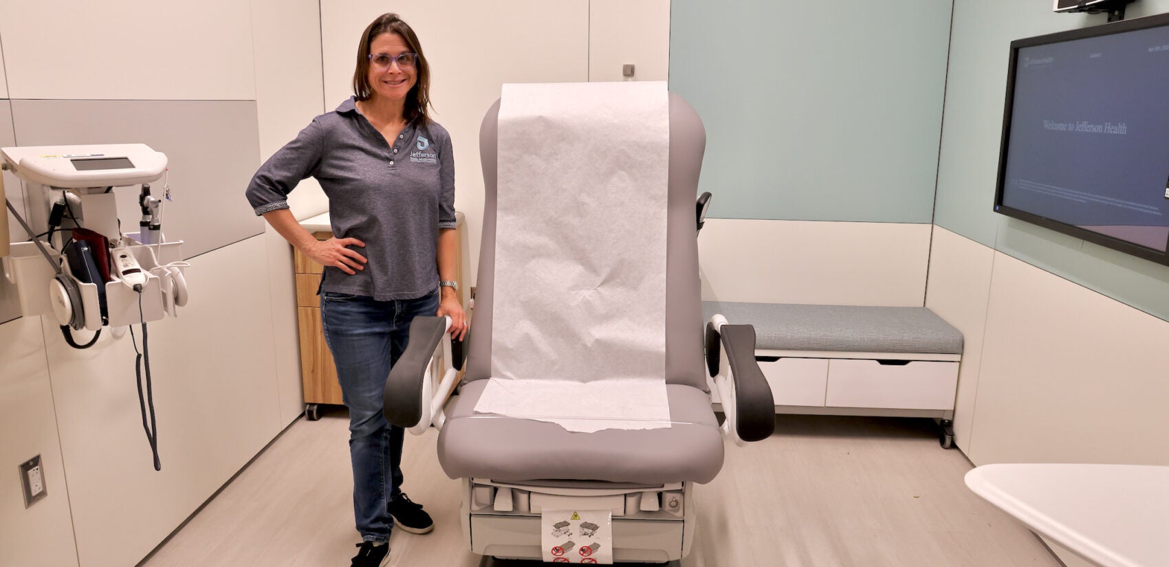 Dr. Wendy Ross stands beside an exam chair at the Honickman Center