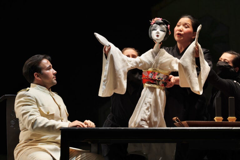 Karen Chia-ling Ho manipulates the puppet that represents Madame Butterfly with the help of two puppeteers.