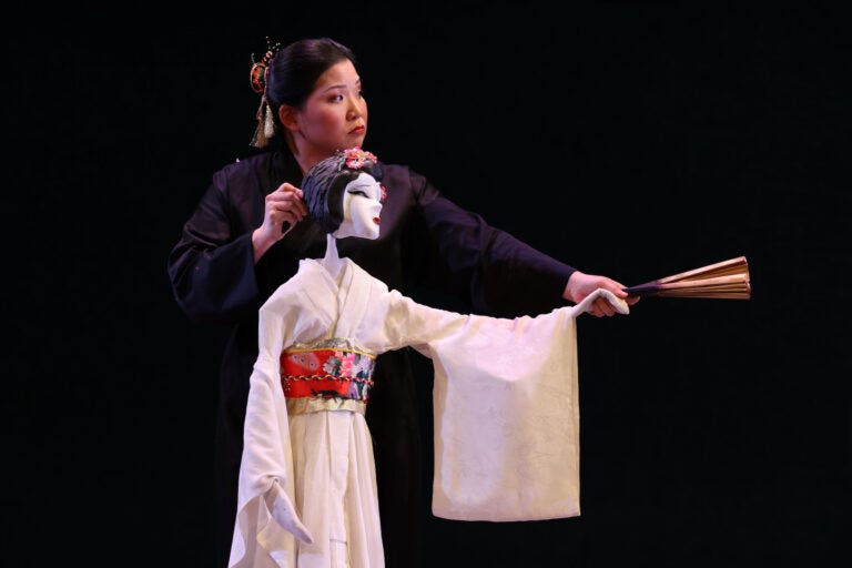 Karen Chia-ling Ho voices and manipulates a puppet in a performance of Madame Butterfly