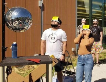Two people wearing eclipse glasses