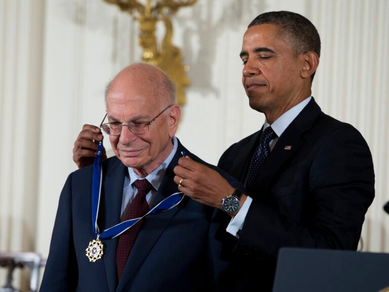 FILE - President Barack Obama awards psychologist Daniel Kahneman with the Presidential Medal of Freedom, Nov. 20, 2013, during a ceremony in the East Room of the White House in Washington. Kahneman, a psychologist who won a Nobel Prize in economics for his insights into how ingrained neurological biases influence decision making, died Wednesday, March 27, 2024, at the age of 90. (AP Photo/Evan Vucci, File)