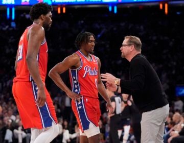 Philadelphia 76ers head coach Nick Nurse (right) talks to Tyrese Maxey (center) and Joel Embiid (left) during the second half of Game 2 in an NBA basketball first-round playoff series against the New York Knicks, Monday, April 22, 2024, in New York.