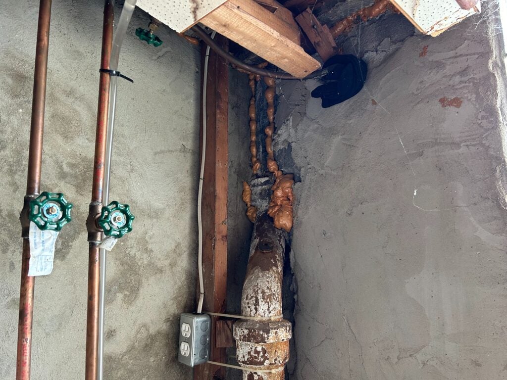 Spray foam fills cracks in a basement wall