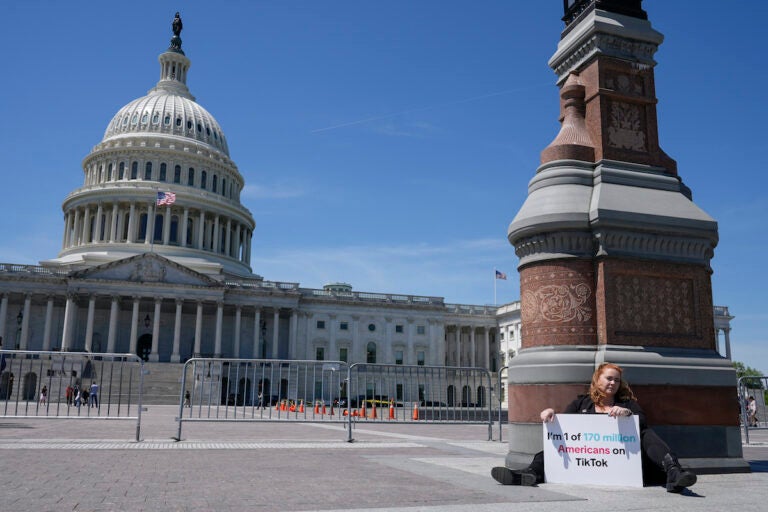 Jennifer Gay, a TikTok content creator, sits outside the U.S. Capitol