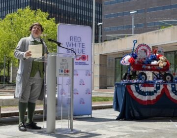 President John Adams portrayed by Peyton Dixon stands outside