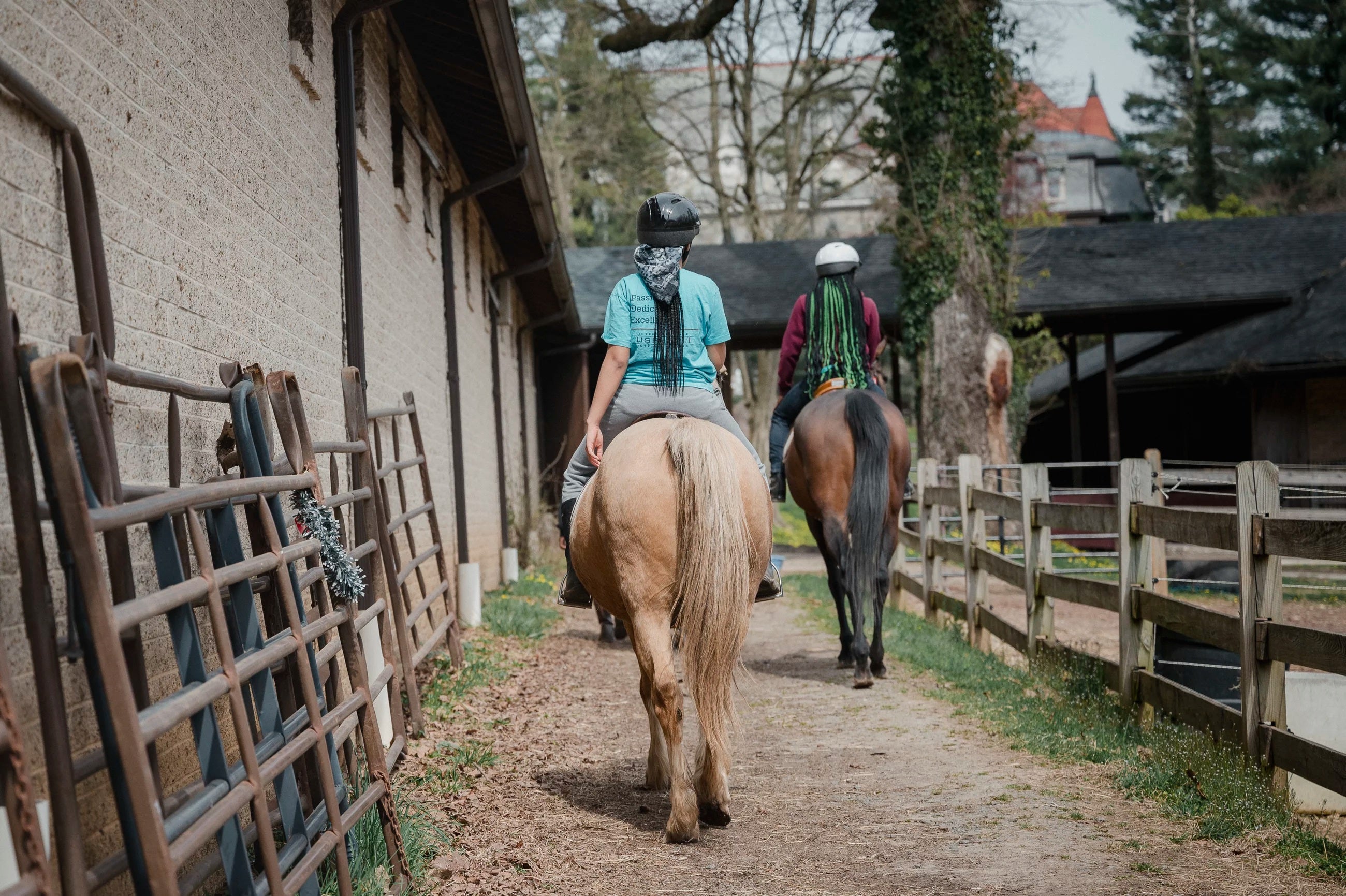 Two riders ride their horses at the Northwestern Stables in Philadelphia