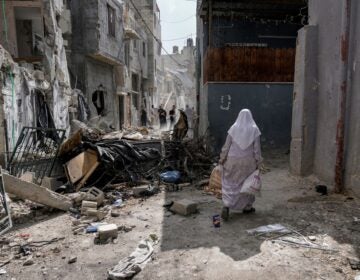 Palestinians inspect the destruction following an Israeli military raid in Nur Shams refugee camp