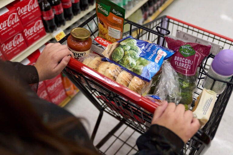 Shopping cart filled with food at the supermarket