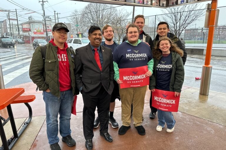 Residents show their support for David McCormick at Geno’s including Congressional candidate Aaron Bashir (second from left) and Billy Walker, president of the College Republicans at Temple University (third from left). (Carmen Russell-Sluchansky/WHYY)