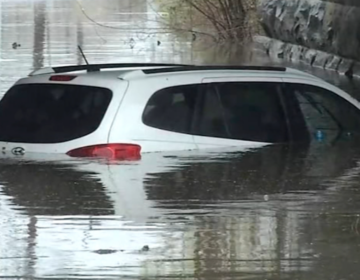 A vehicle is seen under water in Stanton, Delaware