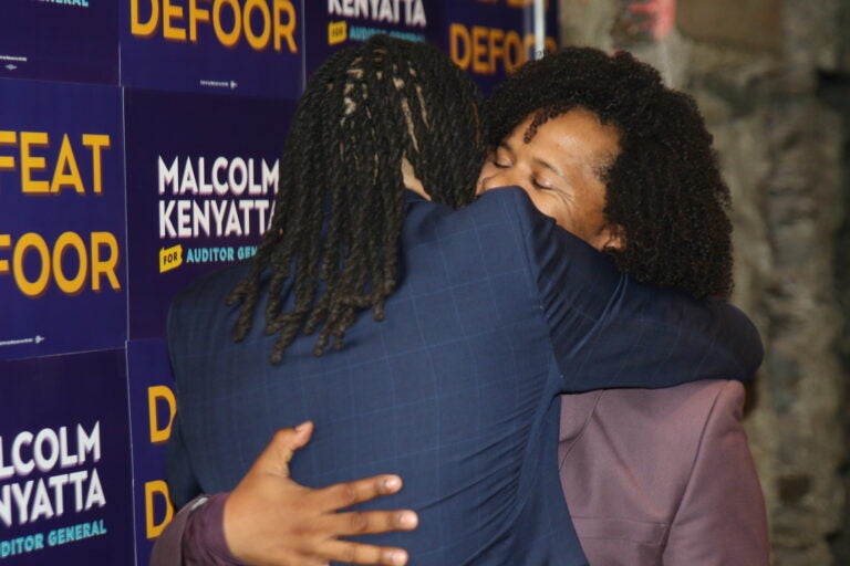 Malcolm Kenyatta and his husband Matthew embrace after his victory