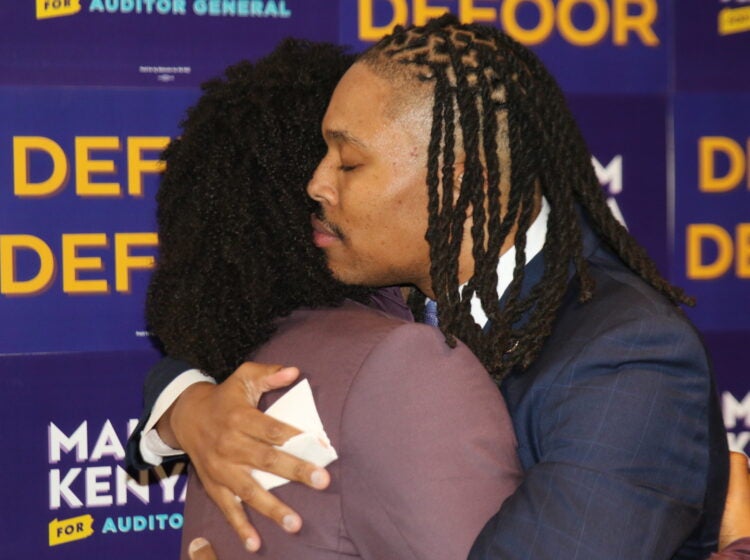 Malcolm Kenyatta and his husband Matthew embrace after his victory