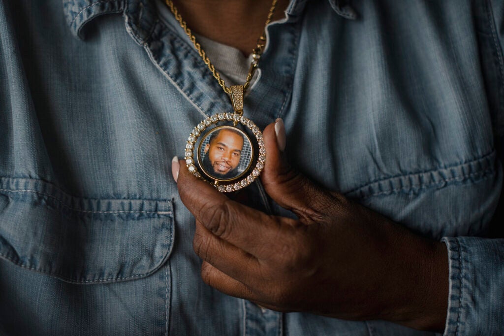 A necklace with a photo of a young man