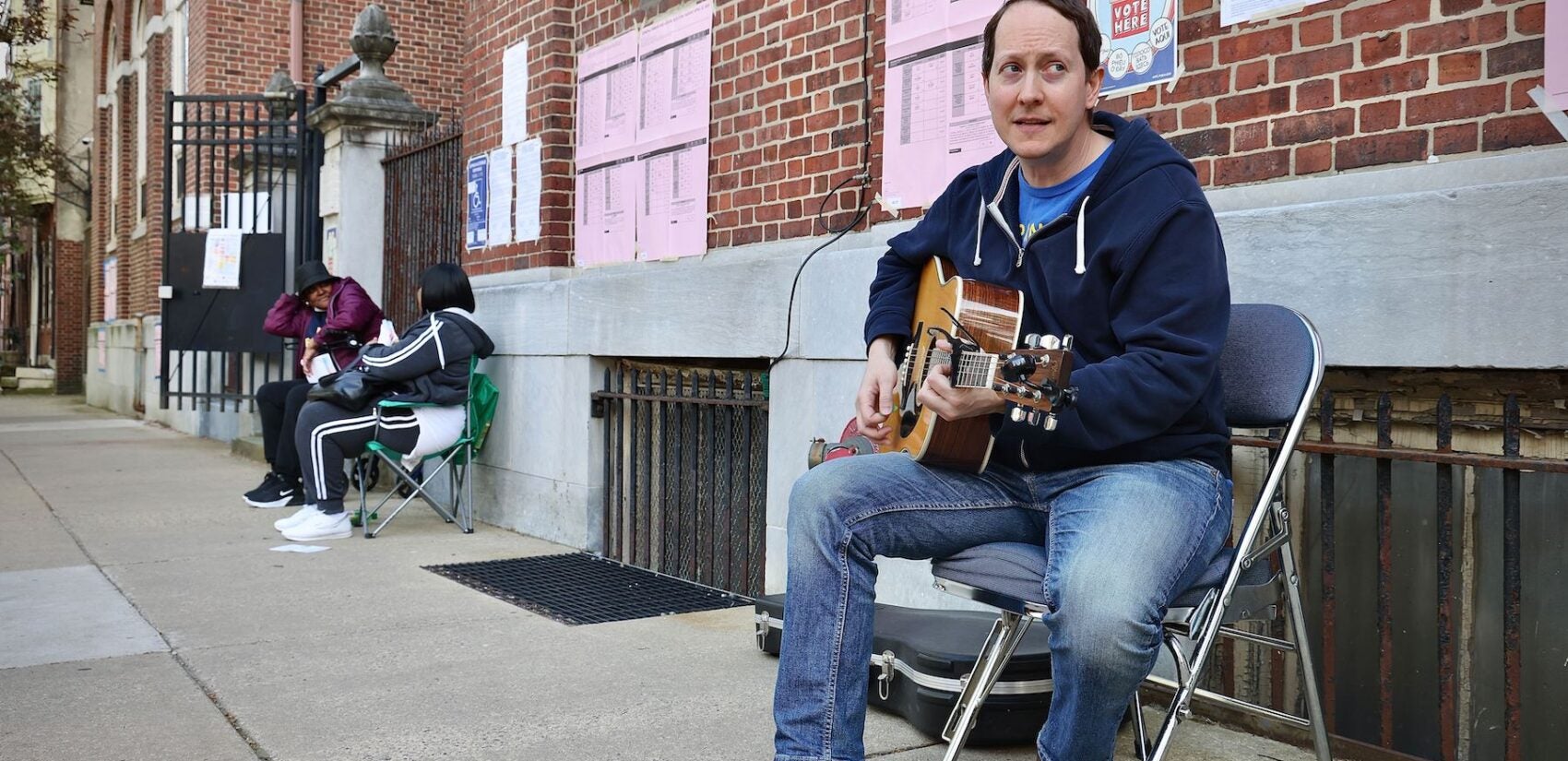 Musician performing in front of a Polling place